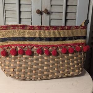 Lebanese handcrafted woven cosmetics bag with pom poms